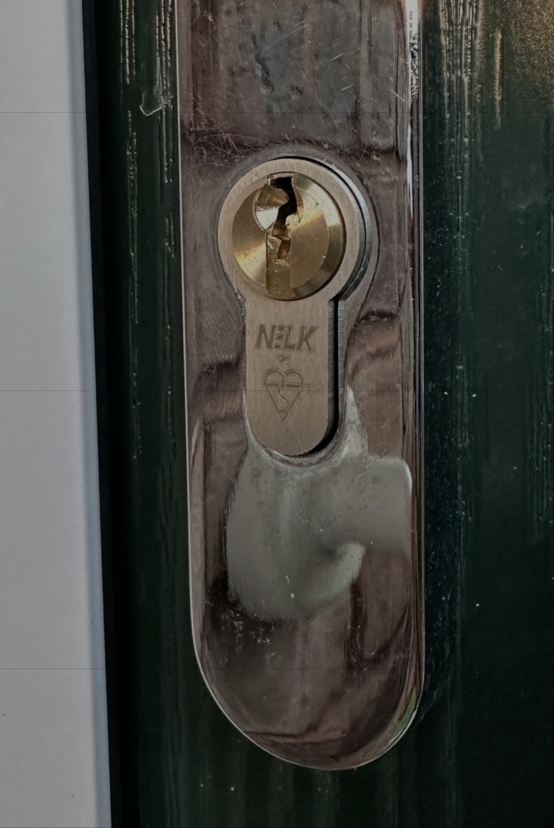 Anti snap euro lock fitted to green door with silver handles