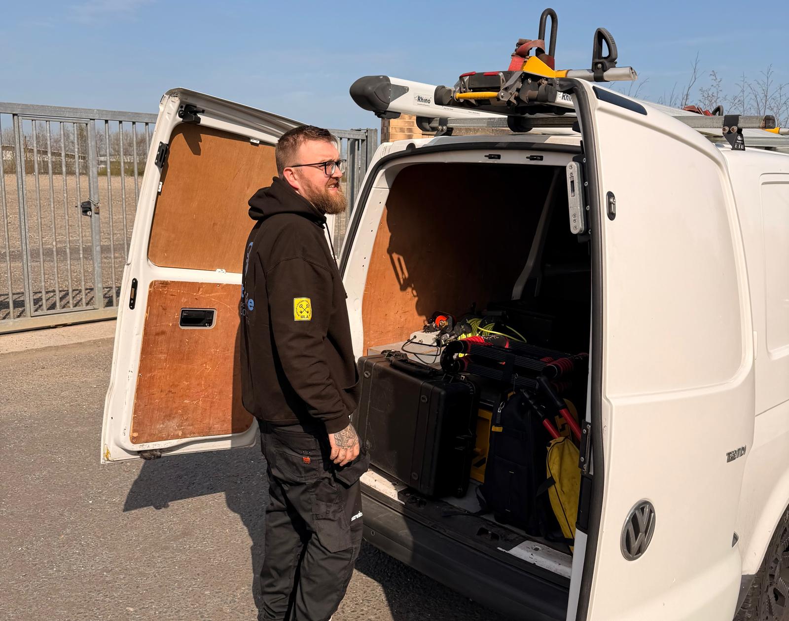 James Howland stood with Stay Safe Locksmiths van in Tynemouth wearing branded black sweatshirt With MLA logo on sleeve 