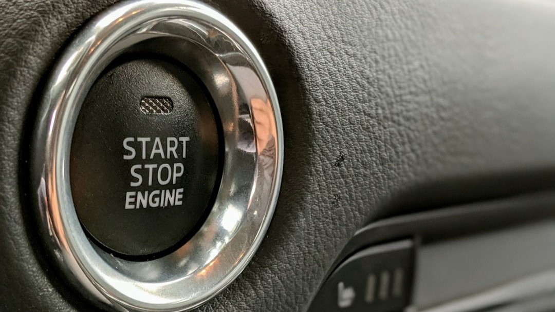 Black push to start button with chrome surround displaying Start, Stop, Engine text in white