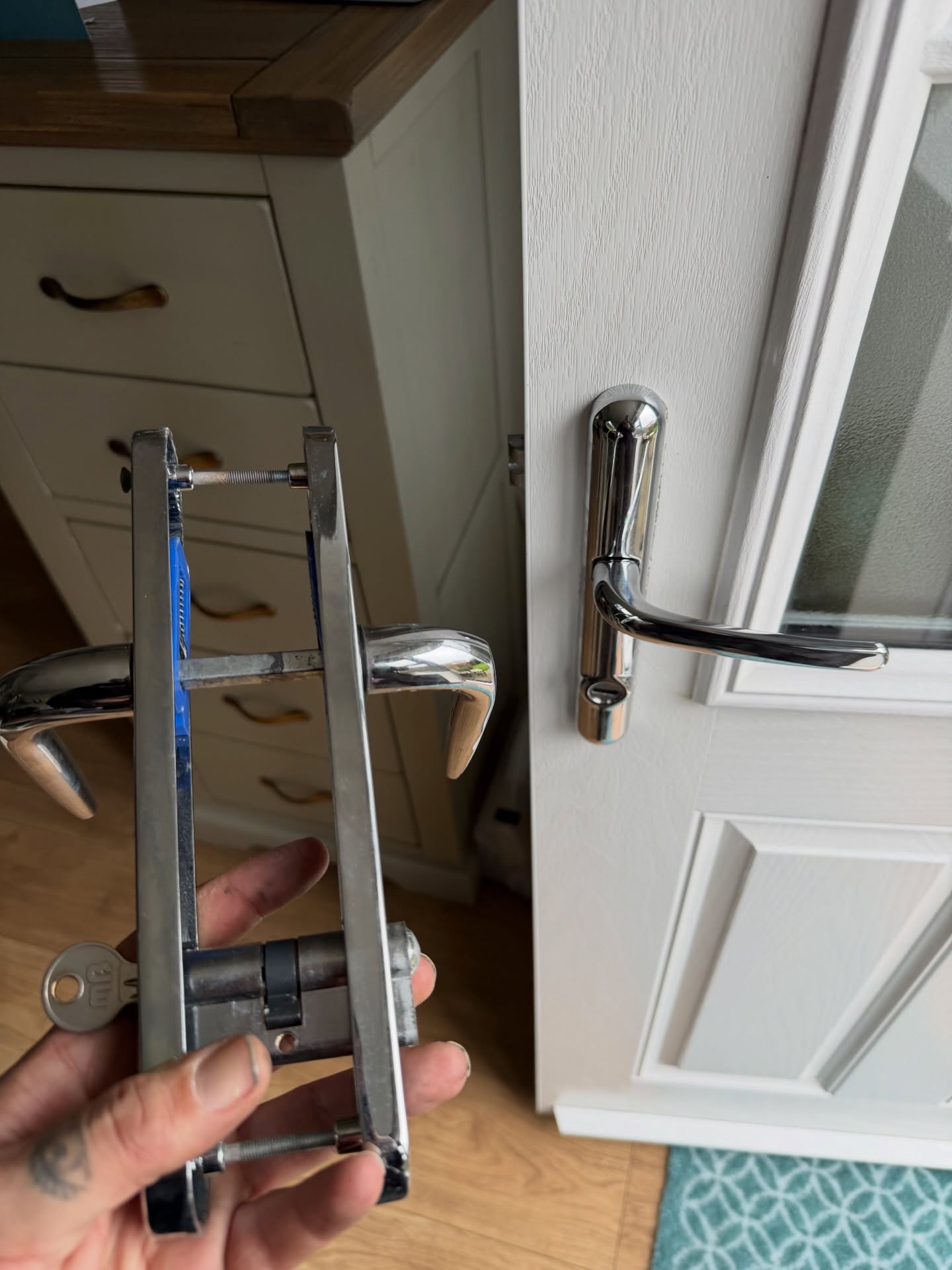 Lock and handles in chrome upgraded on white composite door in Northumberland 