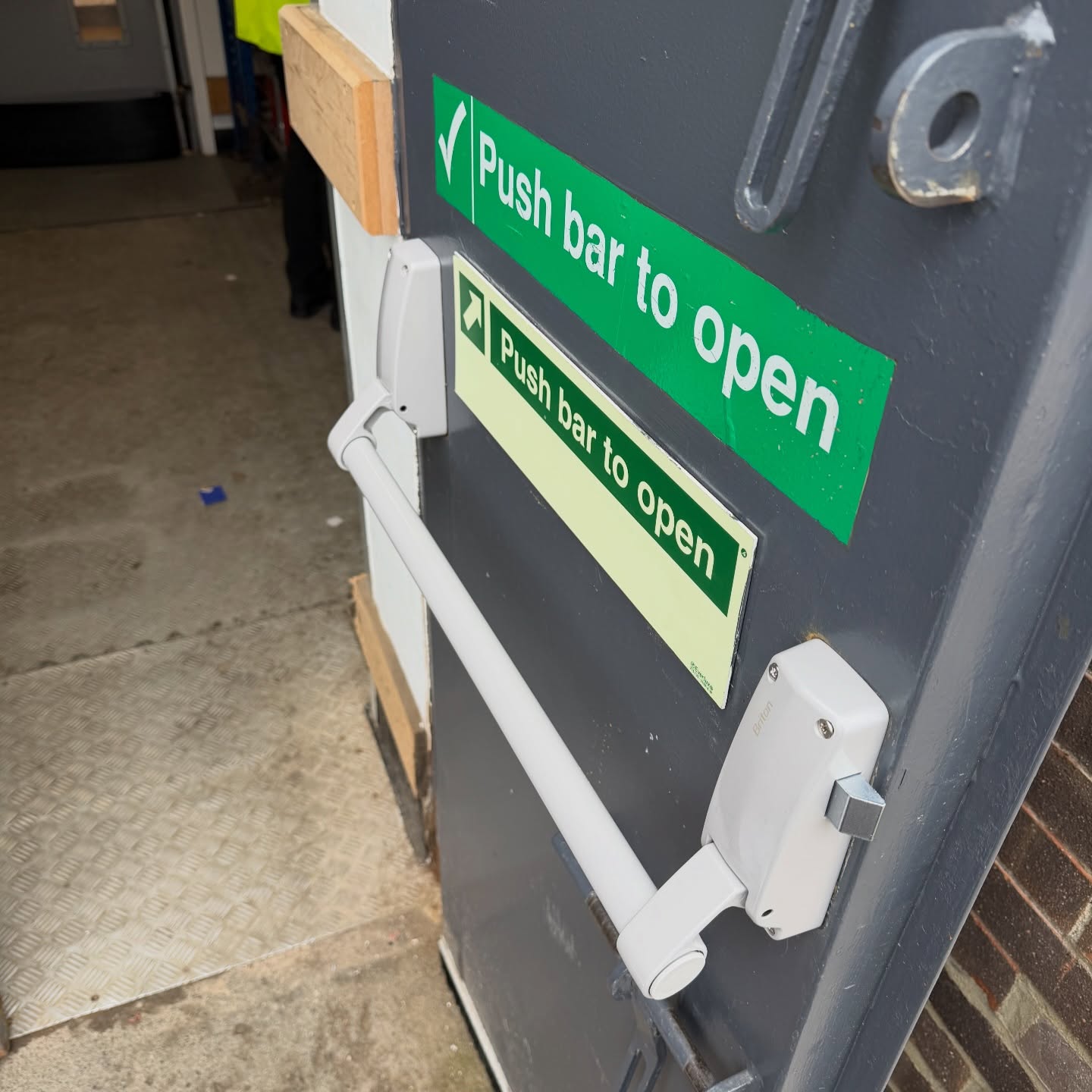 Briton fire exit panic bar fitted to grey steel industrial door