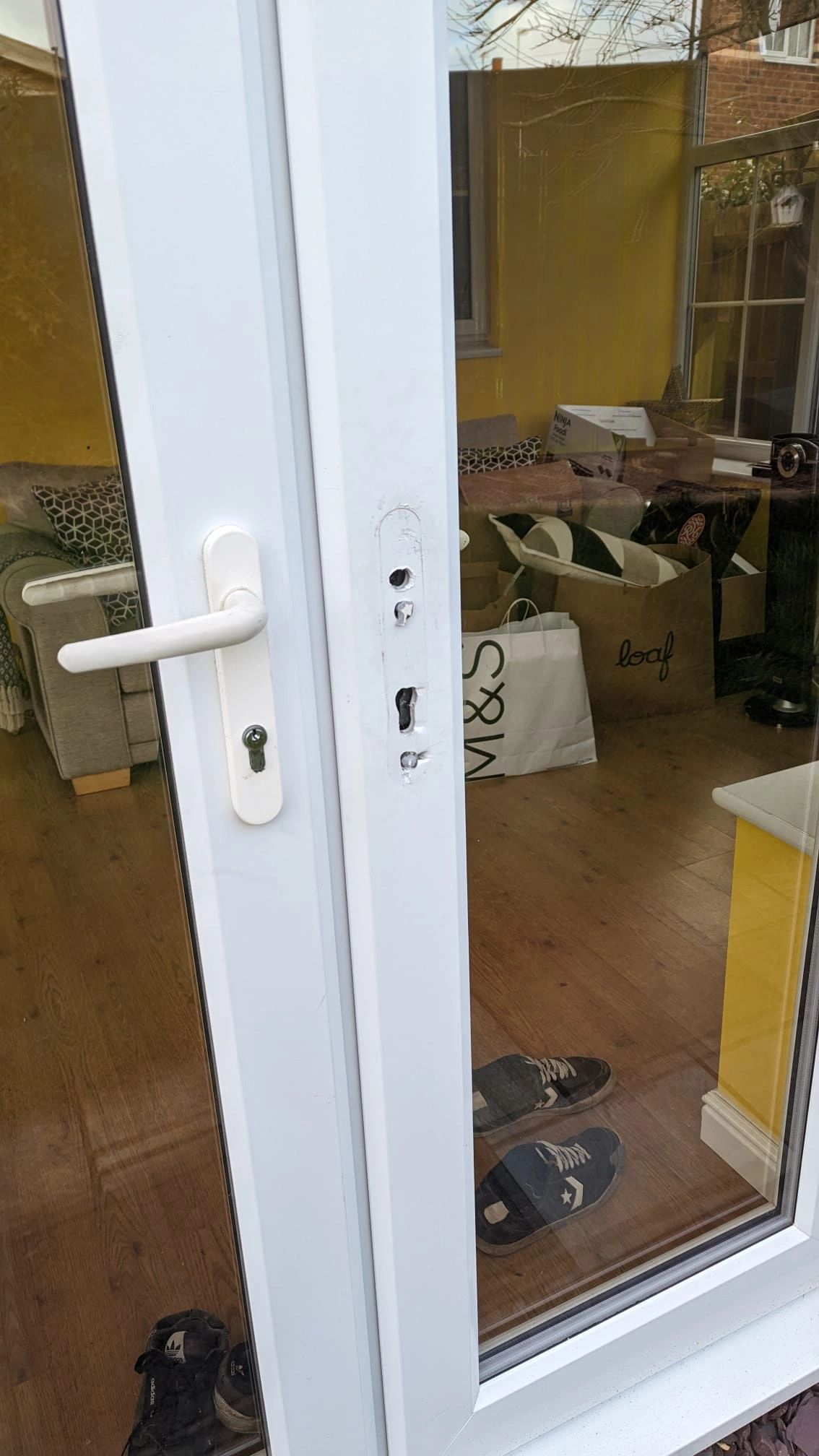 Aftermath of lock snapping burglary on double white patio doors in North Shields 
