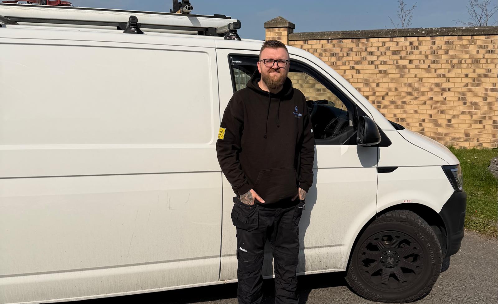 James From Stay Safe Locksmiths Wearing branded hoodie stood next to white van in Cramlington