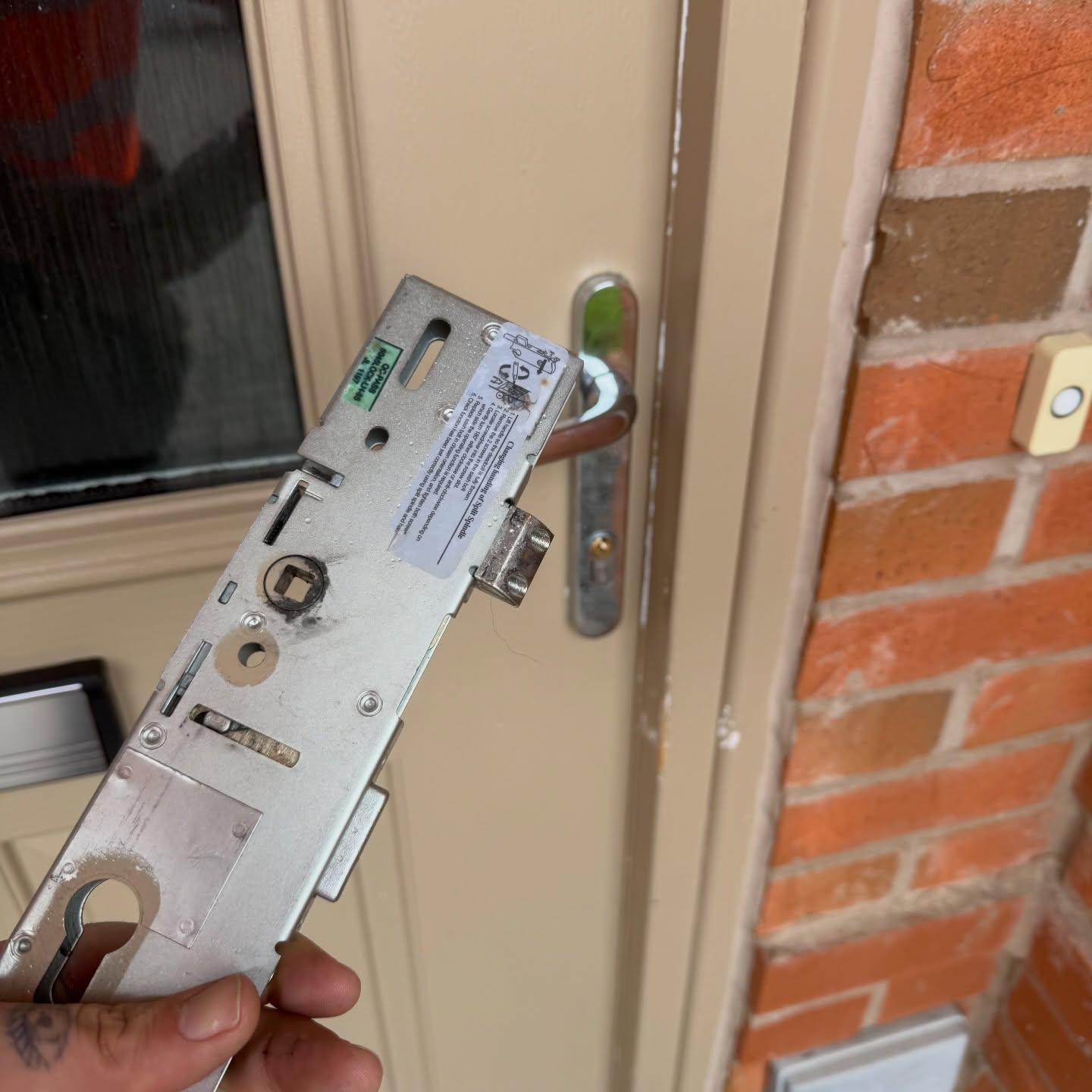 Era gearbox being held up in front of cream coloured upvc door