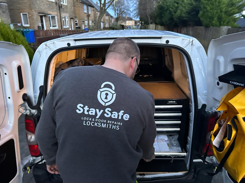 James Howland stood with Stay Safe Locksmiths van wearing branded black sweatshirt 