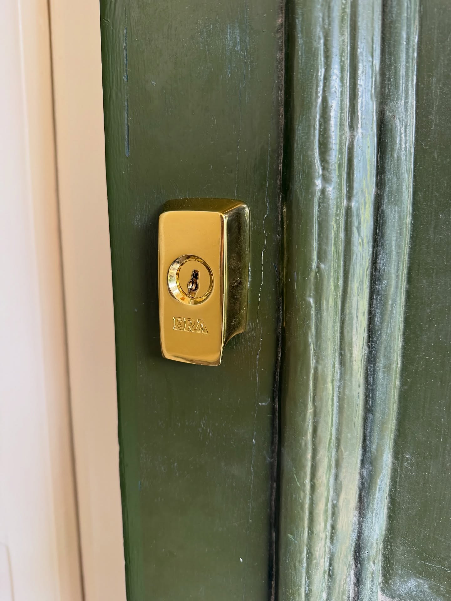 High security brass Yale lock fitted to green wooden door