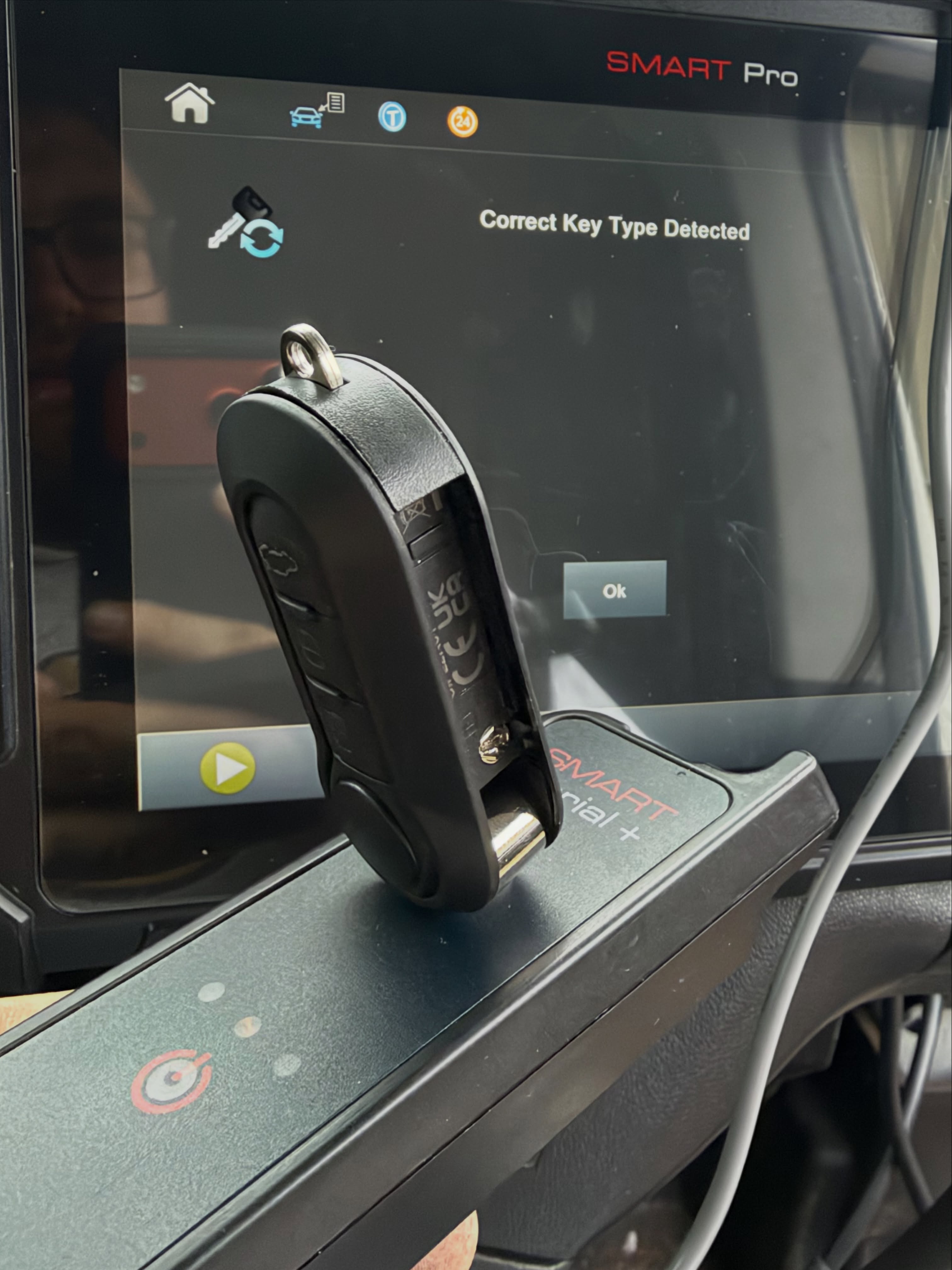 Spare car key being duplicated using Smart Pro key programming machine 