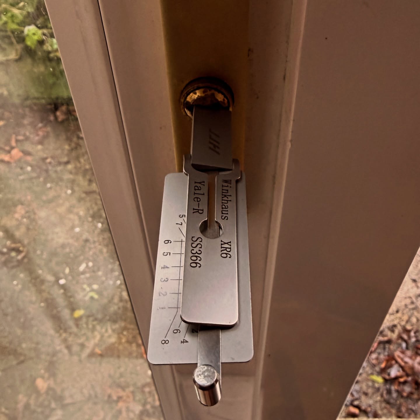Brass euro lock picked open on white door in North Shields 